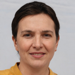 Joyful white adult female with short  brown hair and brown eyes