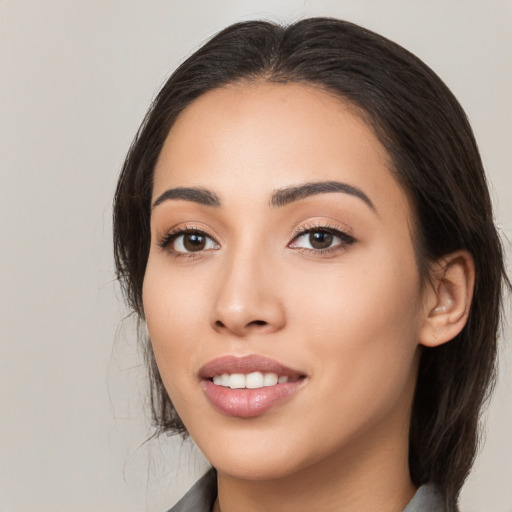 Joyful white young-adult female with medium  black hair and brown eyes