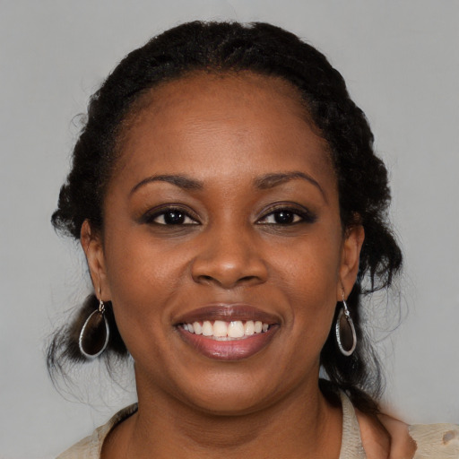 Joyful black young-adult female with medium  brown hair and brown eyes