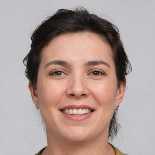 Joyful white young-adult female with medium  brown hair and brown eyes