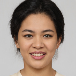 Joyful asian young-adult female with medium  brown hair and brown eyes