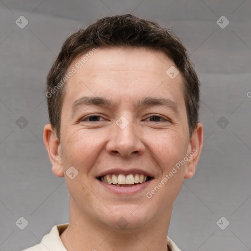 Joyful white adult male with short  brown hair and brown eyes