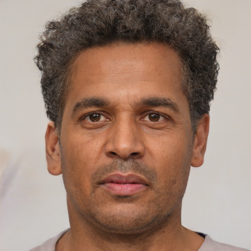 Neutral latino adult male with short  brown hair and brown eyes
