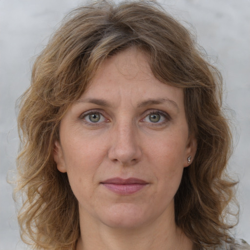 Joyful white adult female with medium  brown hair and grey eyes