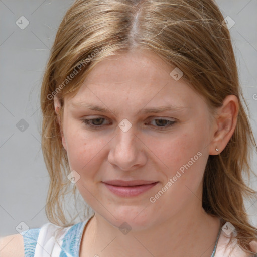 Joyful white young-adult female with medium  brown hair and blue eyes