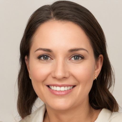 Joyful white young-adult female with medium  brown hair and brown eyes