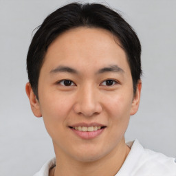 Joyful asian young-adult male with short  brown hair and brown eyes