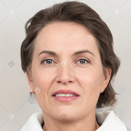 Joyful white adult female with medium  brown hair and grey eyes