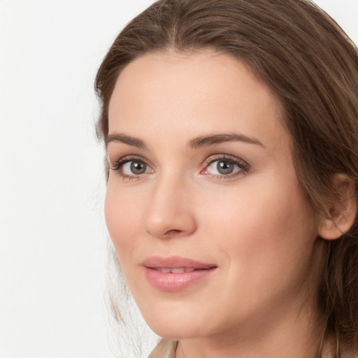 Joyful white young-adult female with long  brown hair and grey eyes