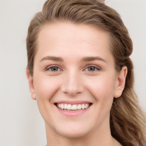 Joyful white young-adult female with long  brown hair and grey eyes