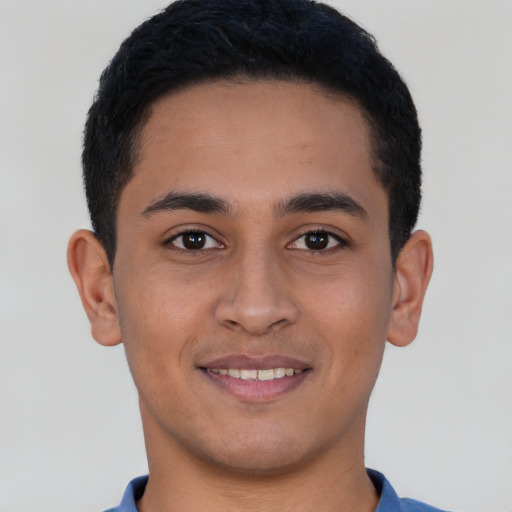 Joyful latino young-adult male with short  brown hair and brown eyes