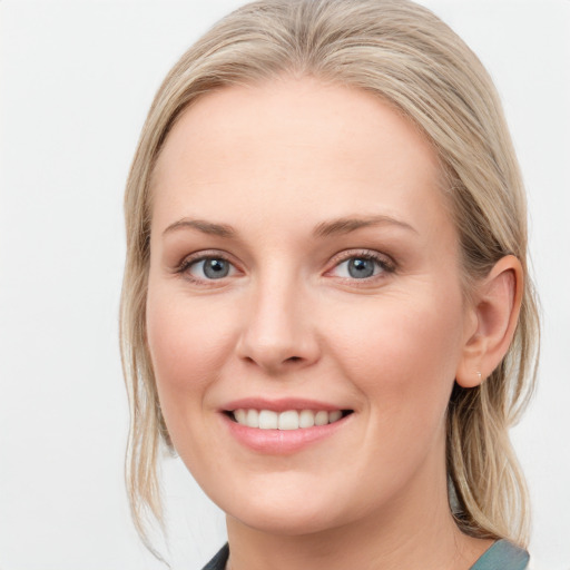 Joyful white young-adult female with medium  brown hair and blue eyes