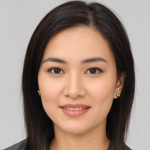 Joyful white young-adult female with long  brown hair and brown eyes