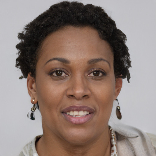 Joyful black adult female with short  brown hair and brown eyes
