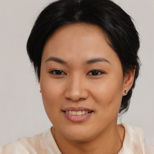 Joyful asian young-adult female with medium  brown hair and brown eyes