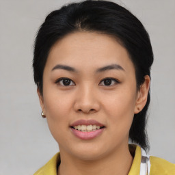 Joyful asian young-adult female with medium  black hair and brown eyes