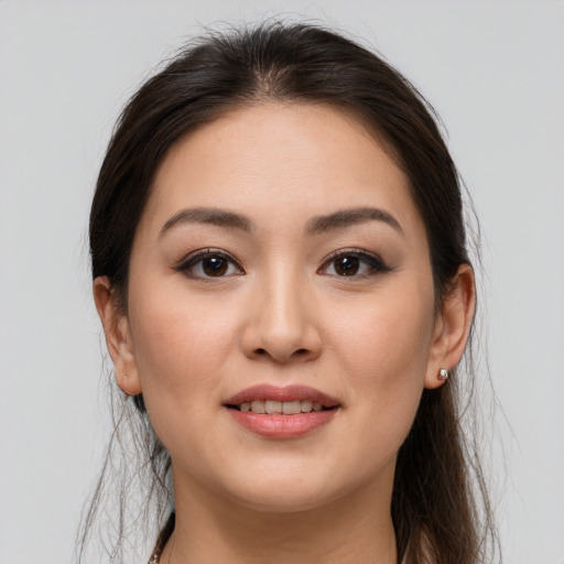 Joyful white young-adult female with long  brown hair and brown eyes