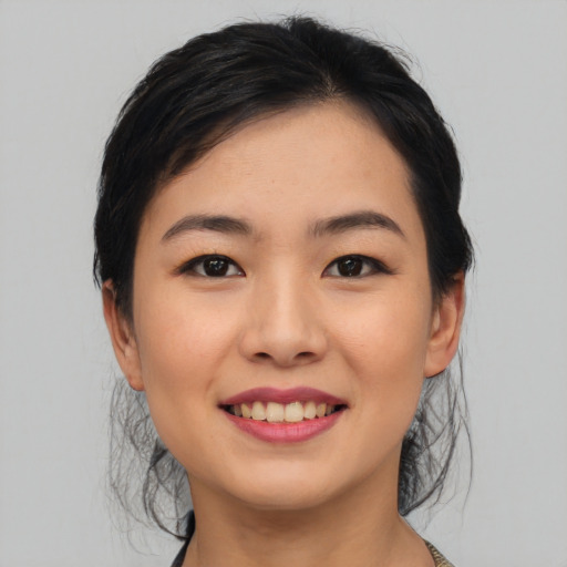 Joyful asian young-adult female with medium  black hair and brown eyes