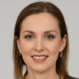 Joyful white young-adult female with long  brown hair and grey eyes