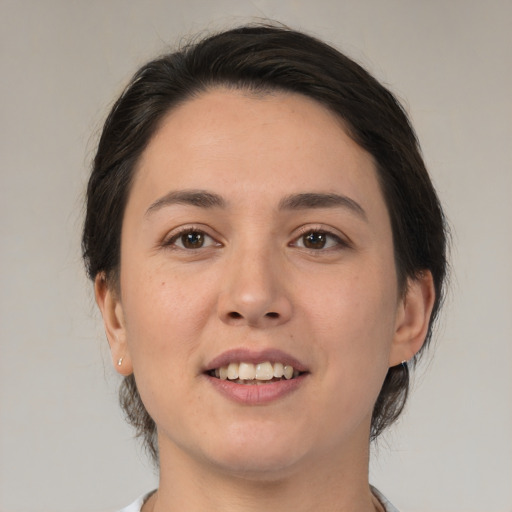 Joyful white young-adult female with medium  brown hair and brown eyes