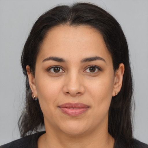 Joyful latino young-adult female with medium  brown hair and brown eyes