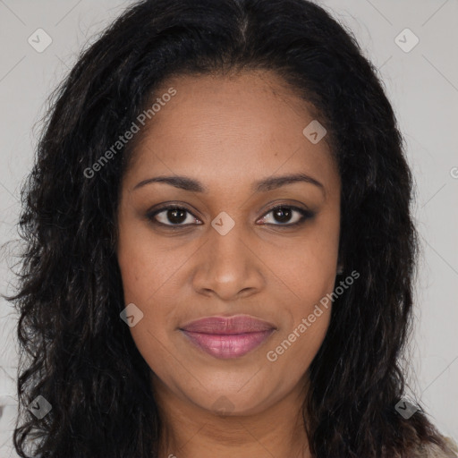 Joyful black young-adult female with long  brown hair and brown eyes
