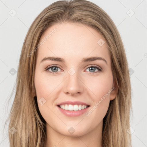 Joyful white young-adult female with long  brown hair and green eyes