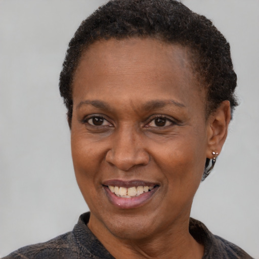 Joyful black adult female with short  brown hair and brown eyes