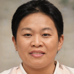 Joyful asian adult female with short  brown hair and brown eyes