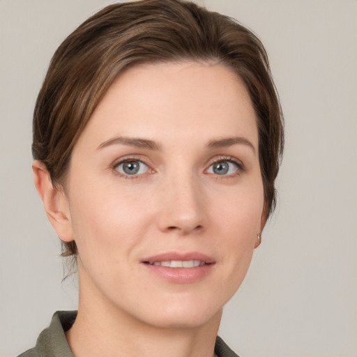 Joyful white young-adult female with medium  brown hair and grey eyes