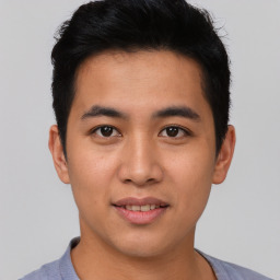 Joyful asian young-adult male with short  black hair and brown eyes