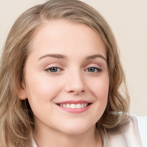 Joyful white young-adult female with long  brown hair and blue eyes