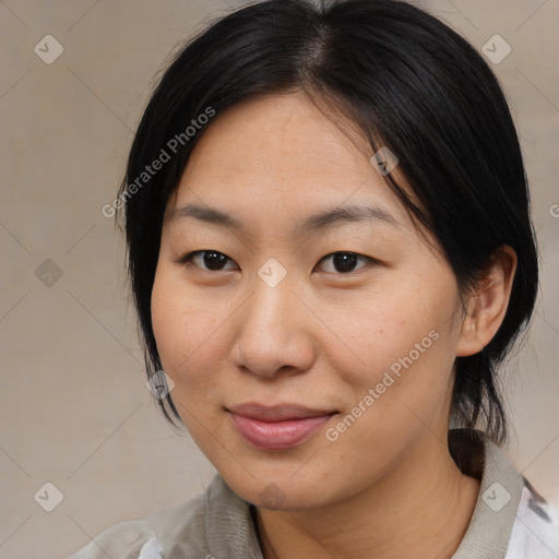 Joyful asian young-adult female with medium  black hair and brown eyes