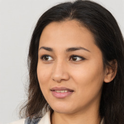 Joyful asian young-adult female with long  brown hair and brown eyes