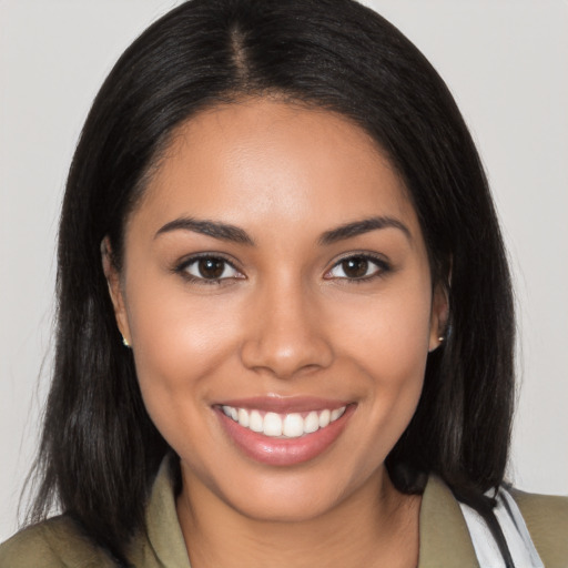 Joyful latino young-adult female with medium  brown hair and brown eyes