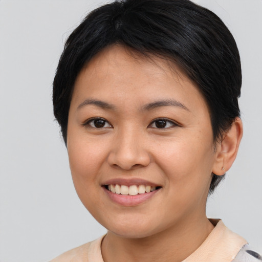 Joyful asian young-adult female with short  brown hair and brown eyes