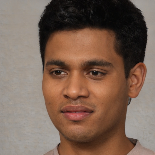 Joyful black young-adult male with short  black hair and brown eyes