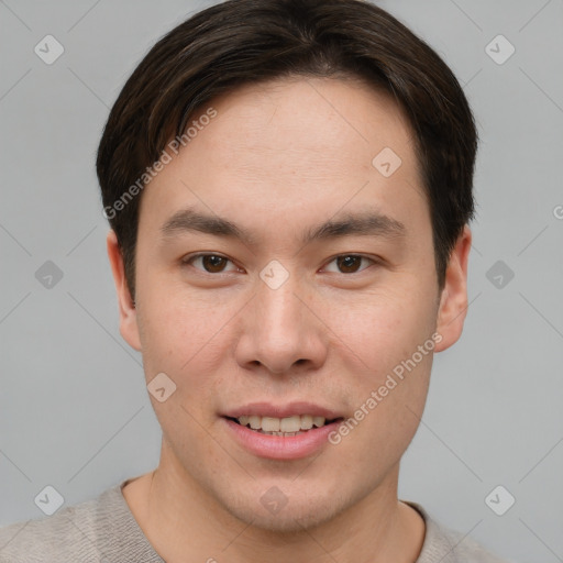 Joyful asian young-adult male with short  brown hair and brown eyes