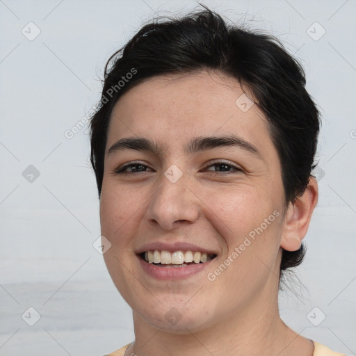 Joyful white young-adult female with short  brown hair and brown eyes