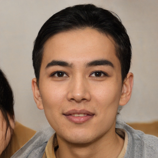 Joyful white young-adult male with medium  black hair and brown eyes