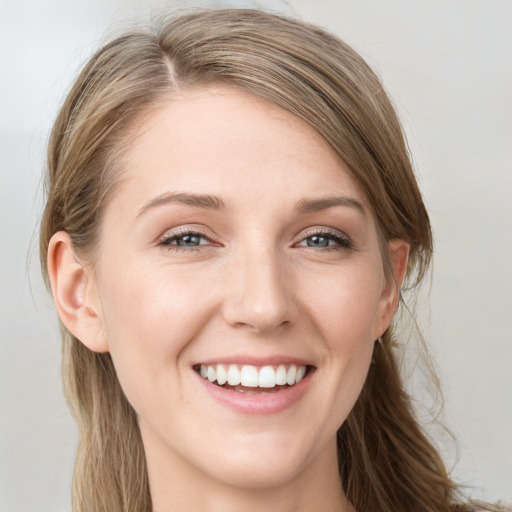 Joyful white young-adult female with long  brown hair and grey eyes