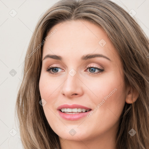 Joyful white young-adult female with long  brown hair and grey eyes