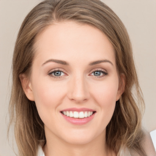 Joyful white young-adult female with long  brown hair and grey eyes