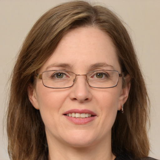 Joyful white adult female with medium  brown hair and green eyes