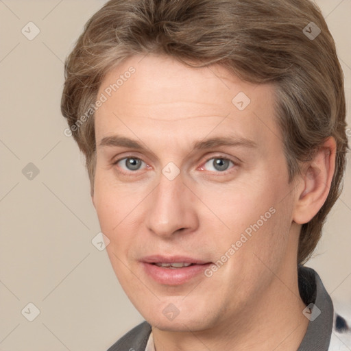 Joyful white adult male with short  brown hair and grey eyes