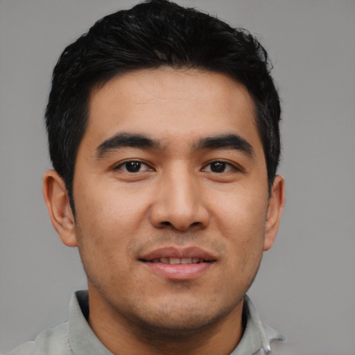 Joyful asian young-adult male with short  black hair and brown eyes