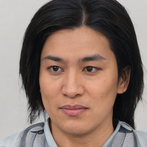 Joyful asian young-adult female with medium  black hair and brown eyes