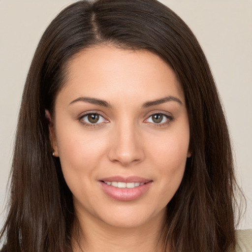 Joyful white young-adult female with long  brown hair and brown eyes