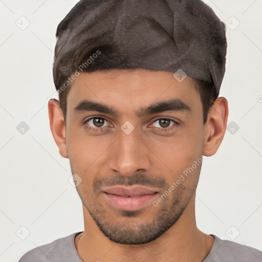 Joyful white young-adult male with short  black hair and brown eyes