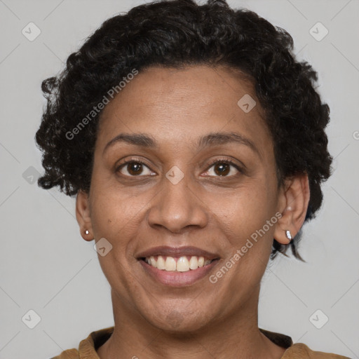 Joyful latino adult female with short  brown hair and brown eyes